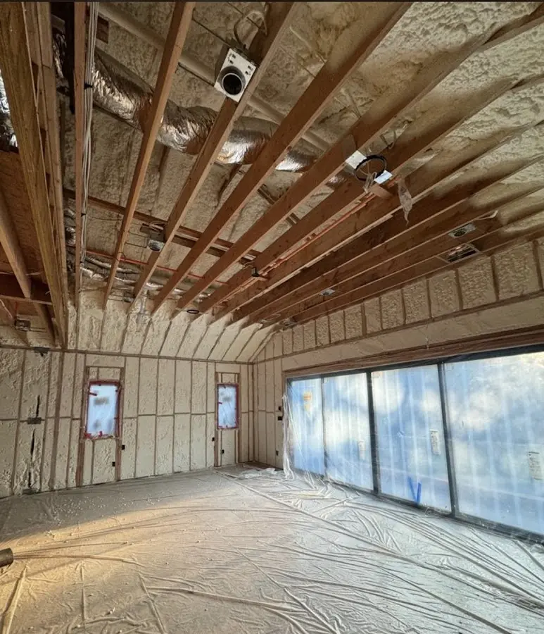 Interior walls and ceiling insulated with spray foam during new construction in Great Neck